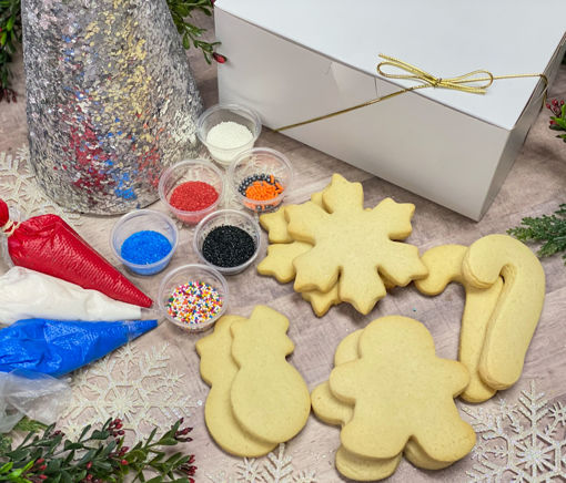 Winter Wonderland Cookie Decorating Kit By Sweet Traders with red, blue, and white frosting and an assortment of sprinkles